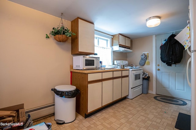 1057 Main St, Great Barrington, MA 01236 - kitchen with white appliances, under cabinet range hood, a baseboard radiator, and light countertops