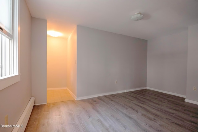 1057 Main St, Great Barrington, MA 01236 - empty room with a baseboard radiator, wood finished floors, and baseboards