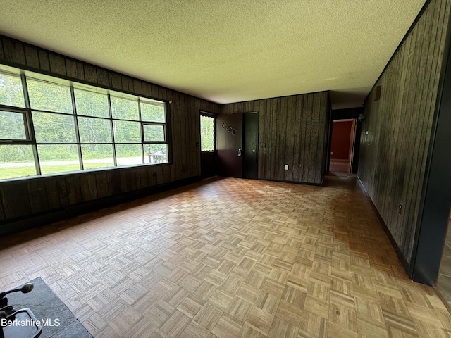 153 Dugway Rd, Lenox, MA 01240 - empty room with wooden walls and a textured ceiling
