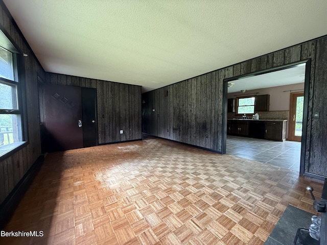 153 Dugway Rd, Lenox, MA 01240 - unfurnished living room with wooden walls and a textured ceiling