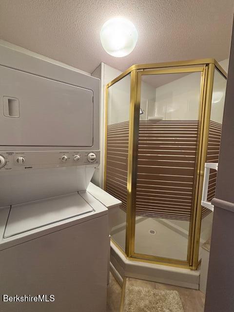 53 Churchill Crst Unit 53, Pittsfield, MA 01201 - laundry room featuring stacked washing machine and dryer and a textured ceiling