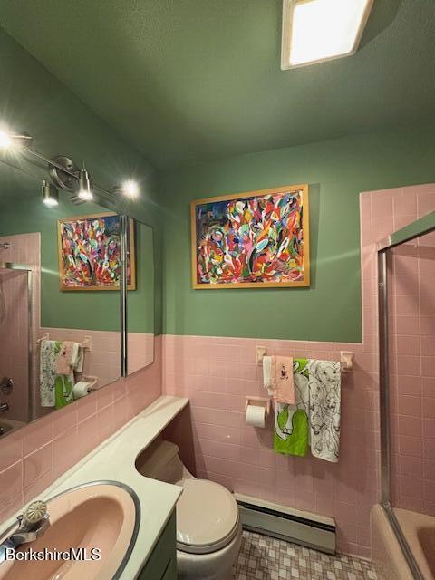 53 Churchill Crst Unit 53, Pittsfield, MA 01201 - full bath featuring a baseboard radiator, tile walls, vanity, combined bath / shower with glass door, and wainscoting