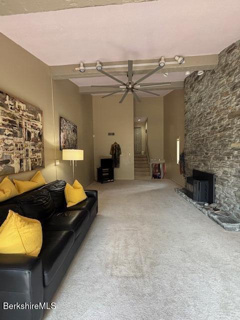 53 Churchill Crst Unit 53, Pittsfield, MA 01201 - living room with carpet floors, a ceiling fan, and a fireplace
