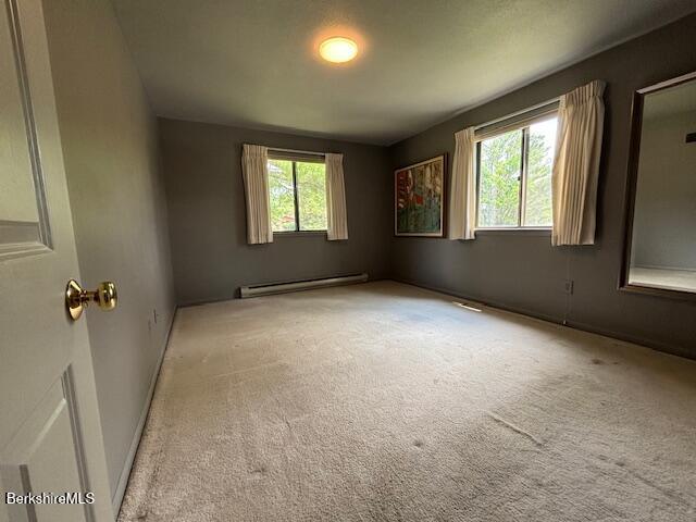 53 Churchill Crst Unit 53, Pittsfield, MA 01201 - carpeted empty room with a baseboard heating unit and baseboards
