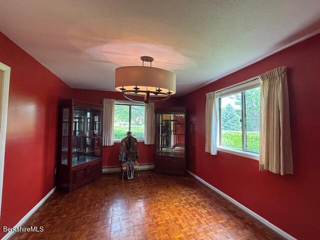 53 Churchill Crst Unit 53, Pittsfield, MA 01201 - dining area featuring plenty of natural light, a chandelier, and baseboard heating