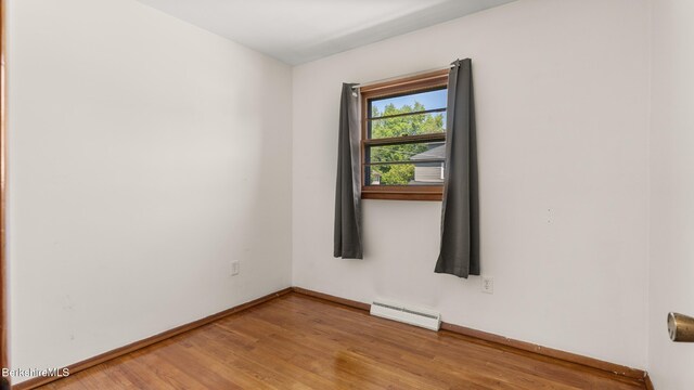 85 Wilson St, Pittsfield, MA 01201 - empty room with a baseboard heating unit and light wood-style flooring