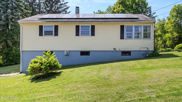 85 Wilson St, Pittsfield, MA 01201 - back of property with a yard and solar panels