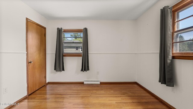 85 Wilson St, Pittsfield, MA 01201 - spare room featuring healthy amount of natural light, light wood-style floors, and a baseboard heating unit