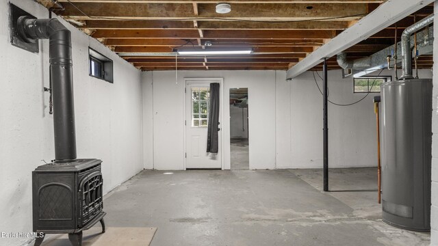 85 Wilson St, Pittsfield, MA 01201 - basement with gas water heater, healthy amount of natural light, and a wood stove