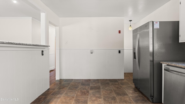 85 Wilson St, Pittsfield, MA 01201 - kitchen with appliances with stainless steel finishes, a wainscoted wall, dark stone finish floors, and decorative light fixtures