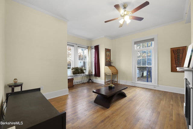 living room with hardwood / wood-style floors, plenty of natural light, ceiling fan, and crown molding