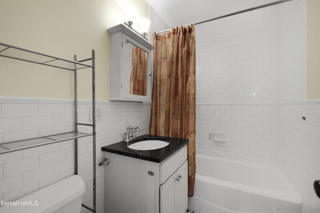 full bathroom featuring shower / bath combination with curtain, toilet, tile walls, and vanity