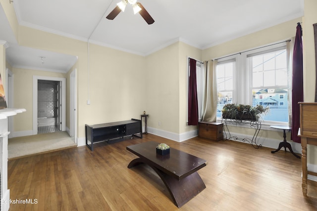 living room featuring ceiling fan, hardwood / wood-style floors, and ornamental molding