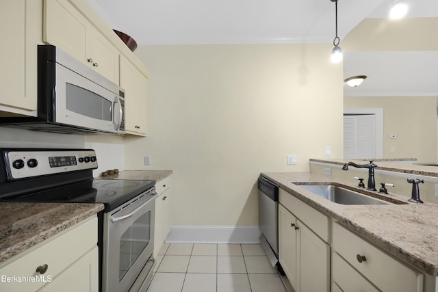 kitchen with hanging light fixtures, crown molding, sink, light tile patterned floors, and appliances with stainless steel finishes