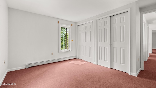 889 George Carter Rd, Becket, MA 01223 - unfurnished bedroom featuring a baseboard heating unit, carpet floors, and multiple closets