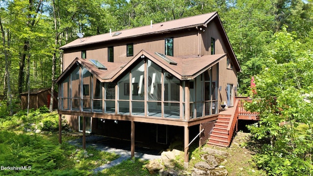 889 George Carter Rd, Becket, MA 01223 - back of property with a sunroom, stairs, a wooden deck, and roof with shingles