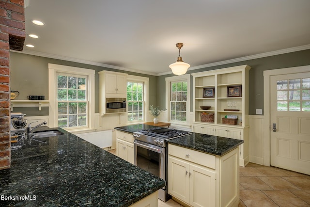 kitchen featuring a sink, open shelves, crown molding, wainscoting, and appliances with stainless steel finishes