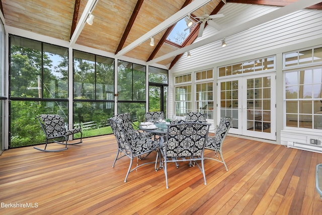 unfurnished sunroom featuring french doors, lofted ceiling with skylight, and ceiling fan