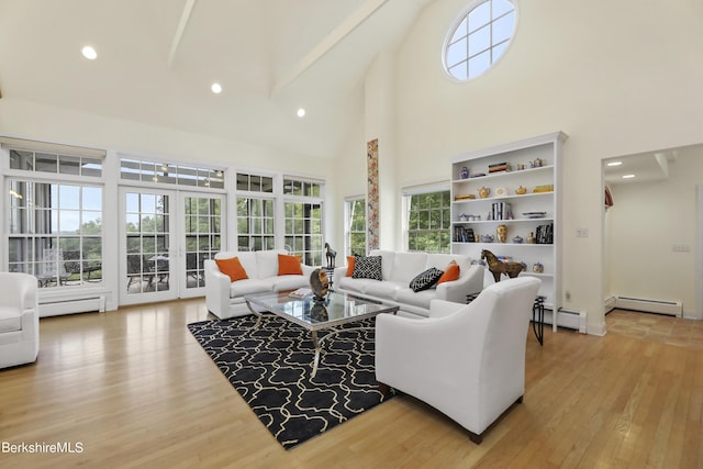 living room with hardwood / wood-style flooring, baseboard heating, and high vaulted ceiling