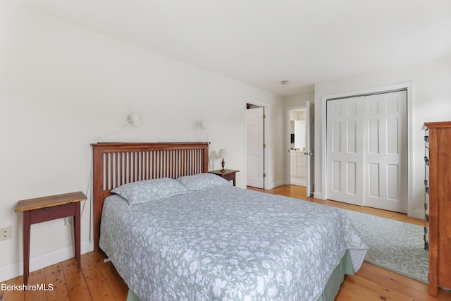 bedroom with a closet and hardwood / wood-style flooring