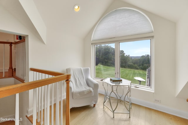 sitting room featuring lofted ceiling and light hardwood / wood-style flooring