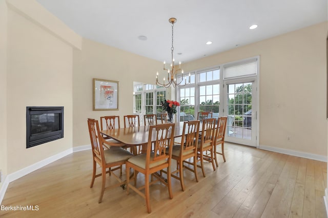 dining area featuring a notable chandelier and light hardwood / wood-style flooring