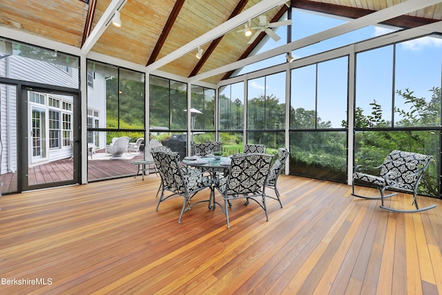 unfurnished sunroom with vaulted ceiling and ceiling fan