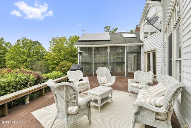 wooden deck featuring a sunroom and french doors