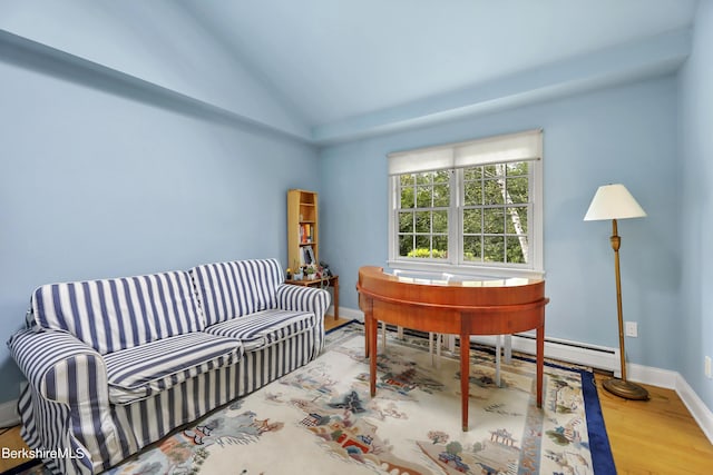 office featuring hardwood / wood-style flooring, vaulted ceiling, and a baseboard radiator