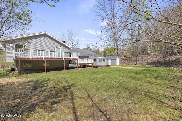 149 Wilshire Dr, Cheshire, MA 01225 - back of house featuring an outdoor structure, a storage unit, a garage, a wooden deck, and a lawn