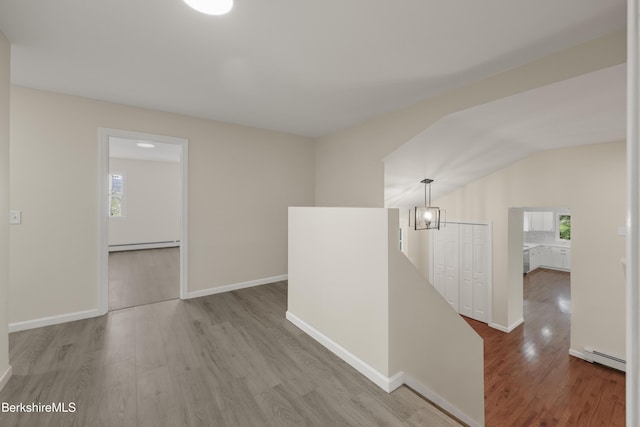 149 Wilshire Dr, Cheshire, MA 01225 - corridor featuring an upstairs landing, wood finished floors, baseboard heating, and lofted ceiling