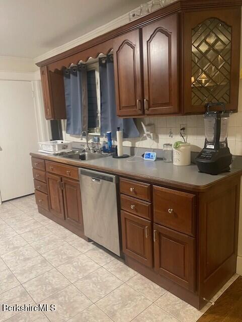 kitchen with tasteful backsplash, sink, stainless steel dishwasher, and light tile patterned flooring