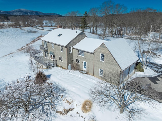 snowy aerial view featuring a mountain view