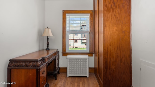 entryway with radiator heating unit and wood finished floors