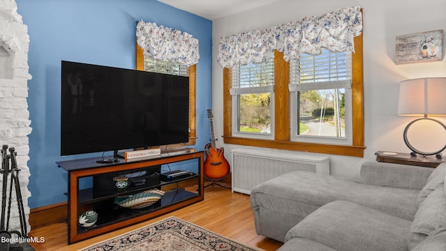 living area featuring radiator heating unit and wood finished floors