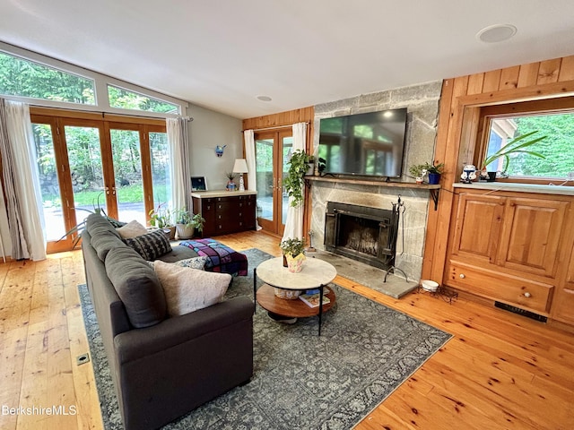 305 Shadow Ln, Sandisfield, MA 01255 - living room featuring french doors, a high end fireplace, light wood-style floors, and vaulted ceiling