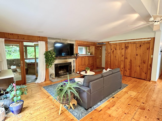 305 Shadow Ln, Sandisfield, MA 01255 - living area featuring hardwood / wood-style flooring, lofted ceiling, wooden walls, a fireplace, and a ceiling fan