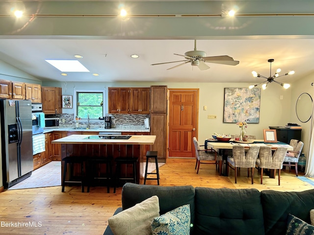 305 Shadow Ln, Sandisfield, MA 01255 - kitchen with stainless steel appliances, light countertops, light wood-type flooring, backsplash, and vaulted ceiling