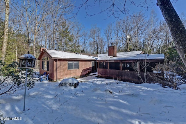 305 Shadow Ln, Sandisfield, MA 01255 - snow covered rear of property with a chimney
