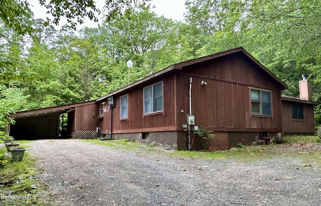 305 Shadow Ln, Sandisfield, MA 01255 - view of front of home featuring a carport, a chimney, and driveway