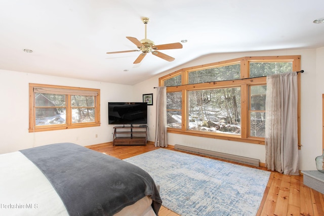 305 Shadow Ln, Sandisfield, MA 01255 - bedroom with a baseboard heating unit, multiple windows, vaulted ceiling, hardwood / wood-style flooring, and ceiling fan