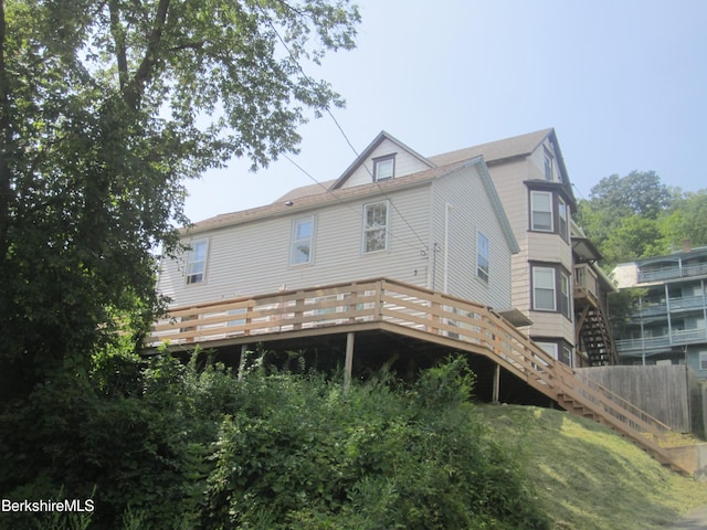 back of house featuring a deck