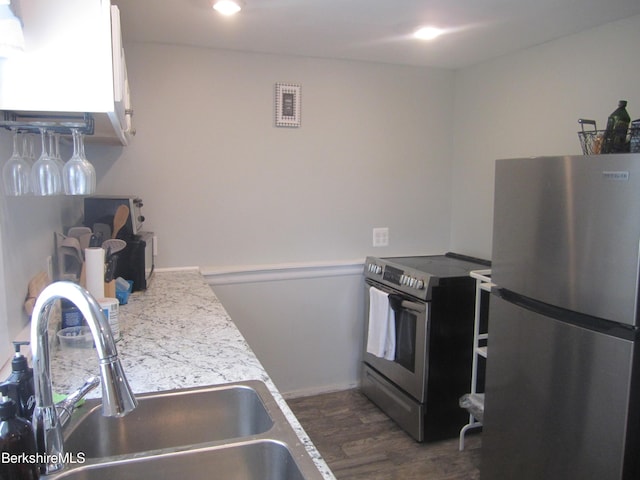 kitchen with dark hardwood / wood-style flooring, sink, white cabinets, and appliances with stainless steel finishes