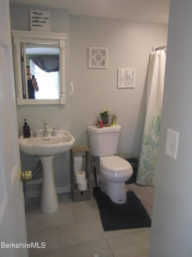 bathroom featuring tile patterned floors, toilet, and sink