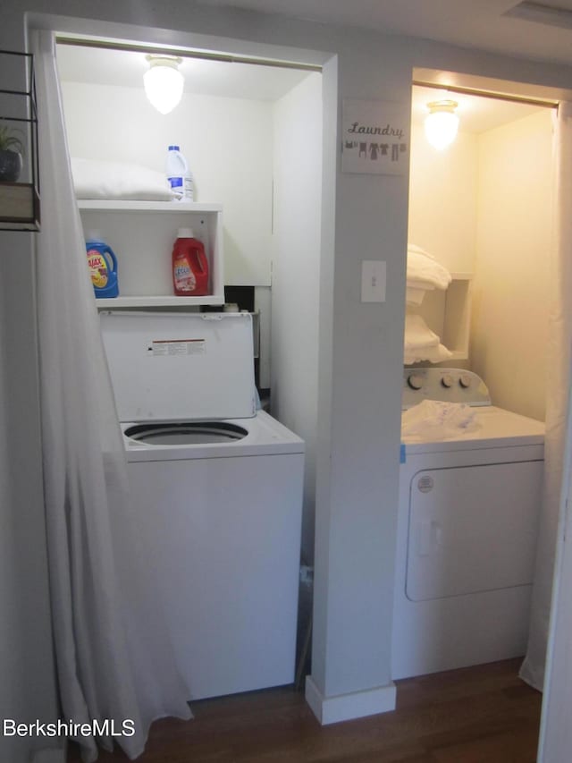 laundry room featuring dark hardwood / wood-style flooring and washer / dryer