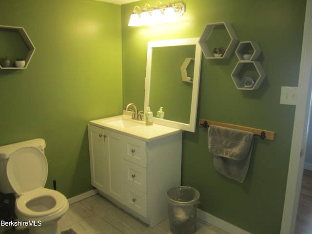 bathroom with tile patterned floors, vanity, and toilet