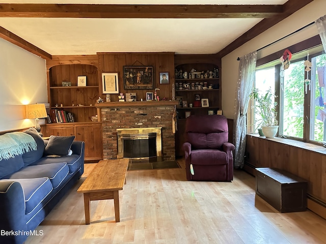 living room featuring a brick fireplace, light hardwood / wood-style flooring, built in features, a baseboard heating unit, and wood walls