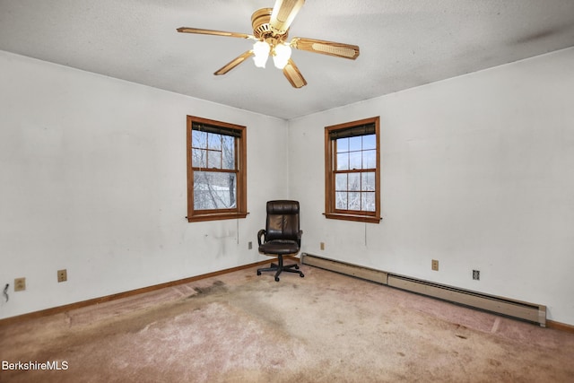 unfurnished room with ceiling fan, a baseboard radiator, carpet flooring, and a wealth of natural light