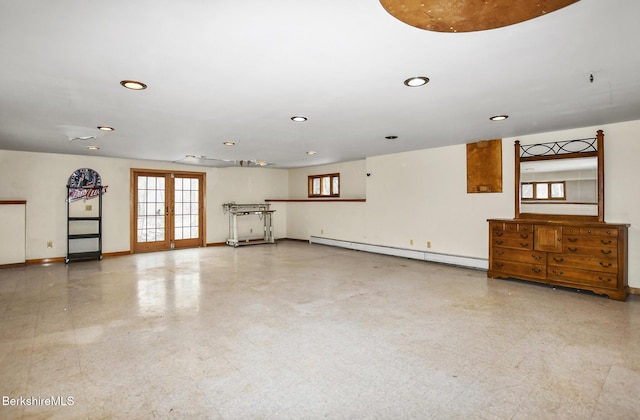 spare room with french doors, a healthy amount of sunlight, baseboards, and baseboard heating