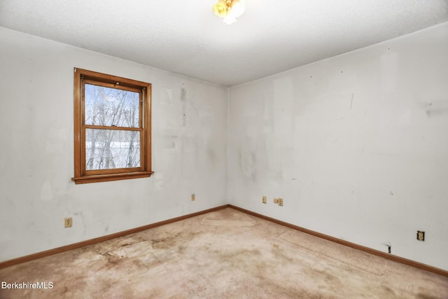 carpeted empty room with baseboards